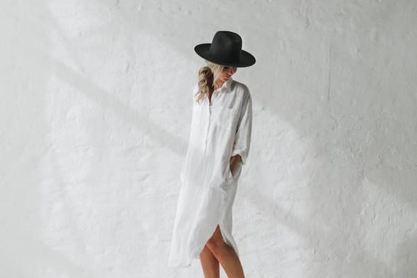 girl with white linen dress and black hat