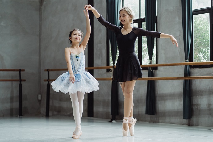 picture of a woman and a little girl in tutus in a studio dancing ballet 