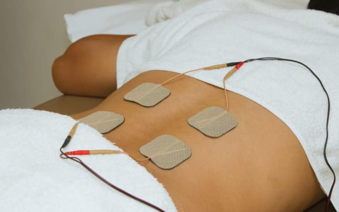 woman wearing a Transcutaneous Electrical Nerve Stimulation machine