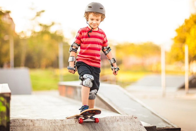 picture of a boy riding a skateboard  with full protective gear