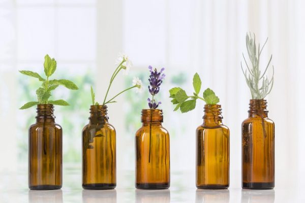 bottles essential oils with flowers